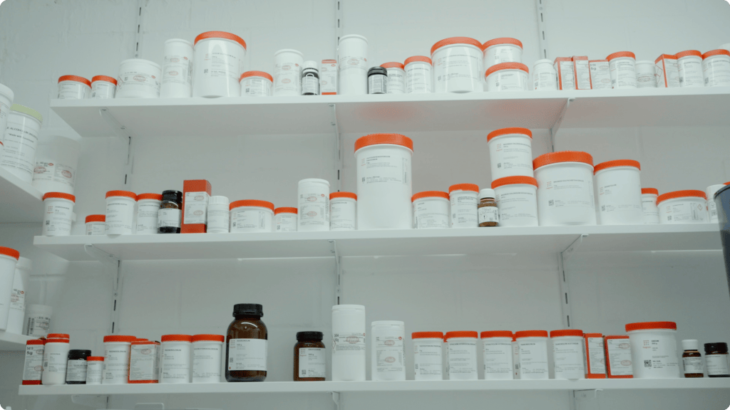 Laboratory reagent bottles on shelves